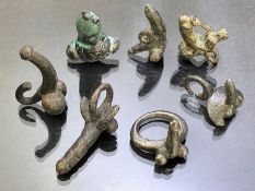 Collection of seven phallic pendants or rings, of varying ages, some possibly Roman, the longest