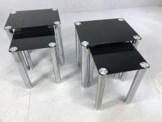 Pair of modern black glass and chrome nests of two tables, largest of each approx 45cm x 35cm x 50cm