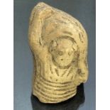 Fragmentary pottery figure, possibly Roman, with depiction of horizontal material markings to