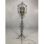 Wrought iron standard lamp with glass suspended shade approx 180cm in height