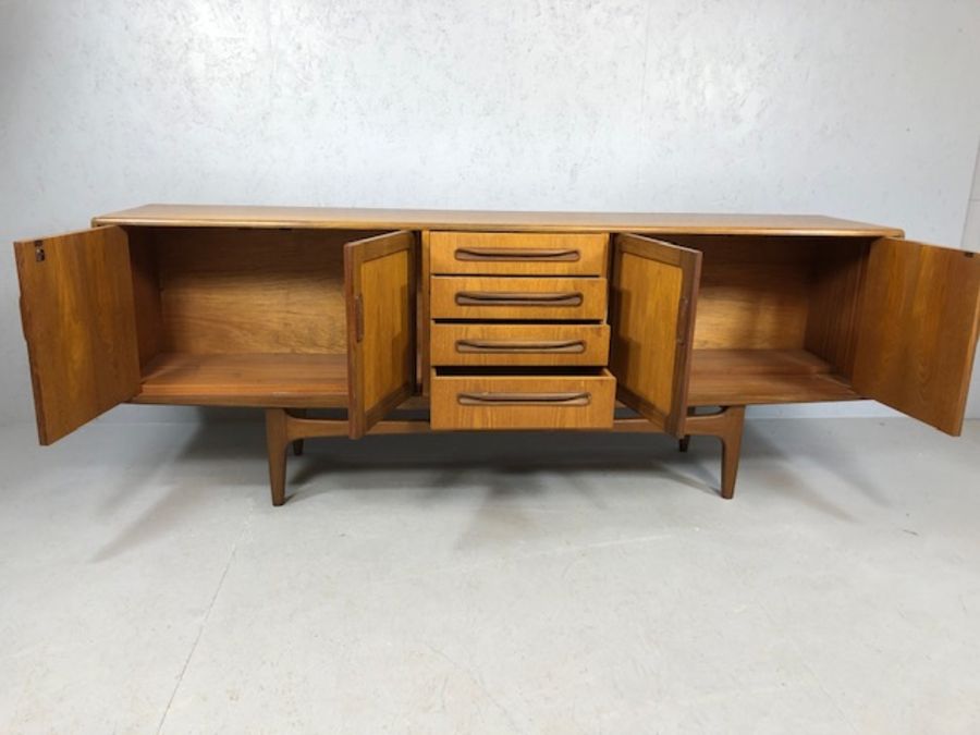 Mid Century red label G-Plan sideboard with cupboards either side and drawers to centre, raised on - Image 2 of 8