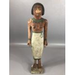 Wooden shabti with black, green and white pigmented detailing to face and body, approx 29 cm in
