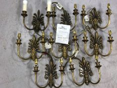 Set of eight boxed cast brass Fleur de Lis design double arm wall lights by Jim Lawrence