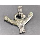 Bronze phallus pendant, clenched fist to one end, phallus to other, with neck hanging attachments,