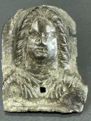 Early bronze repousse work applique in the form of a woman's head, with single square fixing hole,