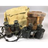 Two pairs of WW1 binoculars, one by L. Petit from Paris and W Watson & Sons from London, with a