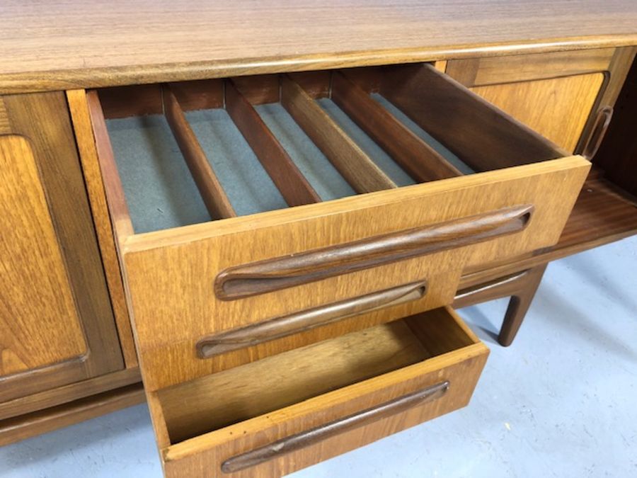 Mid Century red label G-Plan sideboard with cupboards either side and drawers to centre, raised on - Image 4 of 8