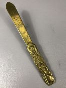 Japanese brass page turner, the handle section modelled in relief with monkey figures on each