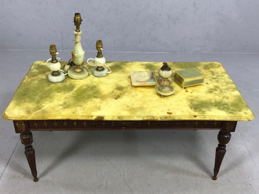 Marble-topped coffee table on wooden frame with a collection of marble dressing table items