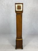 Grandmother clock with carved detailing, pendulum, key and chimes, approx 152cm tall