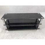 Modern black glass and chrome TV unit, approx 110cm x 33cm x 50cm tall