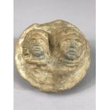 Circular pottery fragment, possibly Roman, with the heads of a male and female, in relief, approx