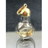 Interesting pendant or charm of a bottle containging Gold flakes with a 14ct Gold lid approx 27mm