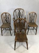 Four wheel back oak chairs, one carver