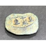 Bronze fragment depicting two suits of armour and theatre mask, reverse with stamp impression,