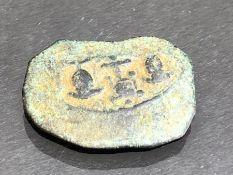 Bronze fragment depicting two suits of armour and theatre mask, reverse with stamp impression,