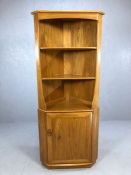 Ercol blond corner unit with two shelves and cupboard under, approx 70cm wide x 179cm tall
