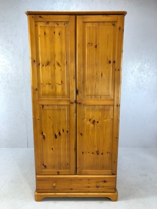 Pine single two door wardrobe with hanging rail and cupboard under, approx 86cm x 52cm x 179cm