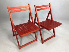 Pair of red wooden folding chairs