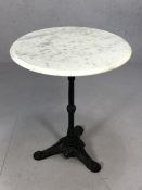 Pub -style bistro table with cast iron base and marble top, approx 60cm in diameter