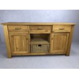 Modern oak sideboard by Wills and Gambier with three drawers, two cupboards and basket drawer,