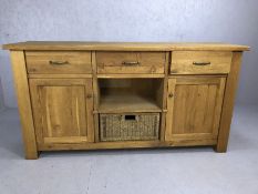 Modern oak sideboard by Wills and Gambier with three drawers, two cupboards and basket drawer,