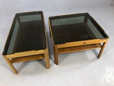 Two Mid Century two tier coffee tables by Myer, with smoky glass tops, the larger approx 88cm x 44cm