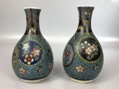 Pair of Cloisonné vases with floral design on blue ground, each approx 12cm in height