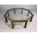 Mid Century style octagonal glass-topped coffee table on eight legs, approx 121cm in diameter