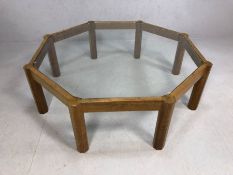 Mid Century style octagonal glass-topped coffee table on eight legs, approx 121cm in diameter