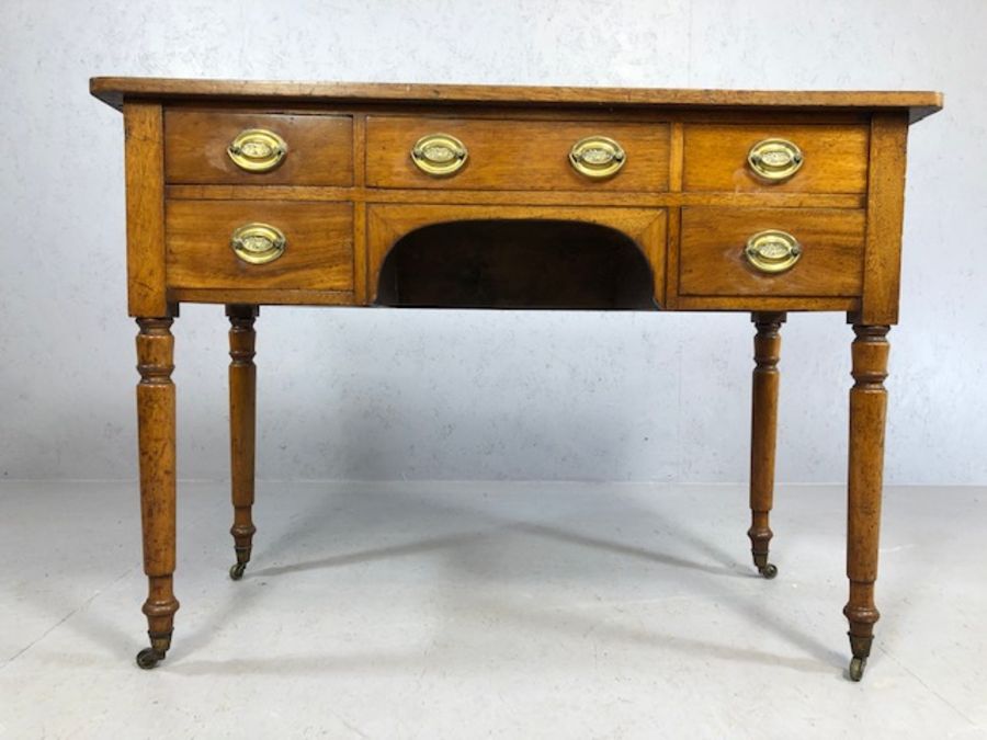 Antique kneehole writing desk on turned legs with original castors, five drawers and brass - Image 4 of 6