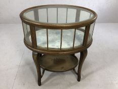 Oak framed glass panelled silver table with shelf beneath, on serpentine legs, upper glass has