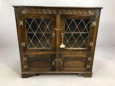 Oak carved sideboard with glazed and leaded doors and cupboard under