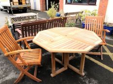 Octagonal teak garden table and two teak folding chairs, table approx 120cm in diameter
