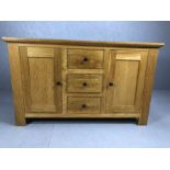 Modern oak sideboard with two cupboards and three drawers, approx 150cm x 49cm x 90cm tall