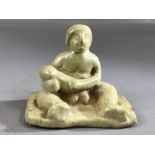 Ceramic figure of a seated man with large phallus, remnants of pale green glaze, approx 7cm wide