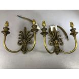 Three pairs of cast brass Fleur de Lis design double arm wall lights by Jim Lawrence