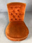 Orange upholstered button back bedroom chair on original china castors