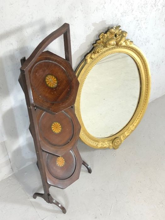 Gilt framed oval mirror and a three tier inlaid folding cake stand - Image 2 of 3