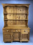 Pine dresser with three drawers and three cupboards under, shelves over, approx 134cm x 45cm x 190cm