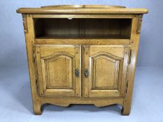 Light oak TV cabinet with swivel top and pull out shelving, approx 93cm x 50cm x 99cm tall