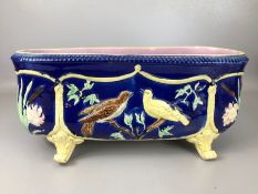 Victorian majolica oblong planter with bird design on a blue background and pink interior glaze,