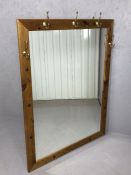 Large pine hall mirror with five brass hooks, approx 106cm x 137cm