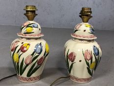 Pair of Dutch ceramic lamp bases decorated with tulips, each approx 33cm in height