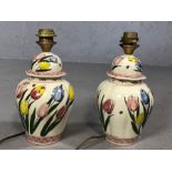 Pair of Dutch ceramic lamp bases decorated with tulips, each approx 33cm in height