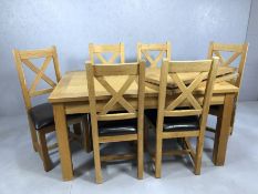 Modern oak extending dining room table with five chairs, table approx 220cm x 90cm fully extended