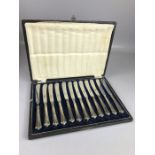 Boxed set of twelve knives hallmarked for maker John Biggin. Silver handled butter knives with FIRTH