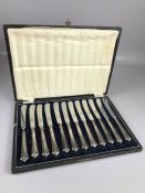 Boxed set of twelve knives hallmarked for maker John Biggin. Silver handled butter knives with FIRTH