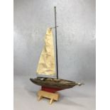 Wooden scale model of a sailing boat, on stand (A/F), approx 69cm in length