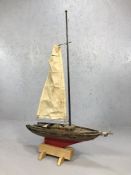 Wooden scale model of a sailing boat, on stand (A/F), approx 69cm in length